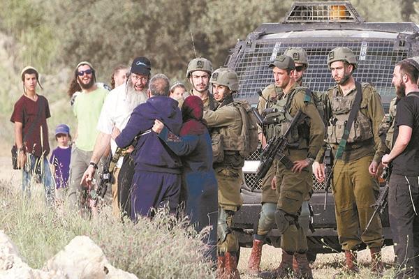 جنود الاحتلال يتابعون مشادة بين مزارعين فلسطينيين ومستوطنين فى الضفة     