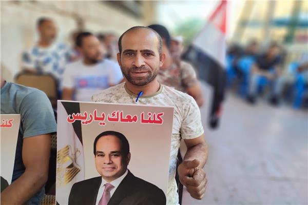 مواطن محتضن صورة السيد الرئيس عبدالفتاح السيسي من أمام مكتب الشهر العقاري 
