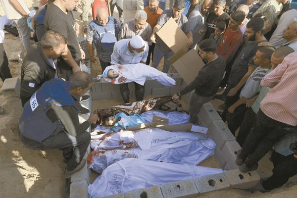 فلسطينيون يجمعون جثامين الشهداء