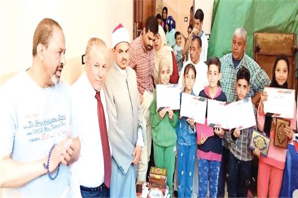 د. جمال زايد يتوسط الدكتور مسعد الشايب مع عدد من أطفال حفظة القرآن الكريم