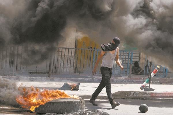تصاعد الدخان جراء اشتباكات بين متظاهرين وقوات الاحتلال فى جنين
