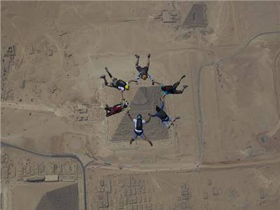 صور|مهرجان القفز بالمظلات.. 130 سائح يقفزون من ارتفاع 15 ألف قدم فوق الأهرامات