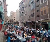 صور| على غرار «اللمة حلوة».. شباب التحرير ينظمون مائدة إفطار في قنا