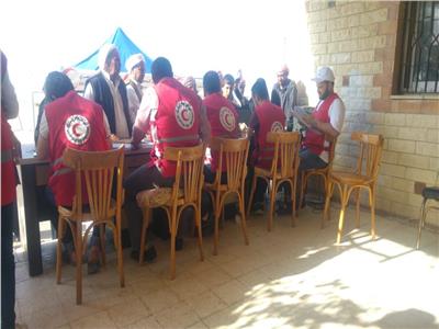 صور| الهلال الأحمر يوزع مساعدات على 400 أسرة بقرية الروضة