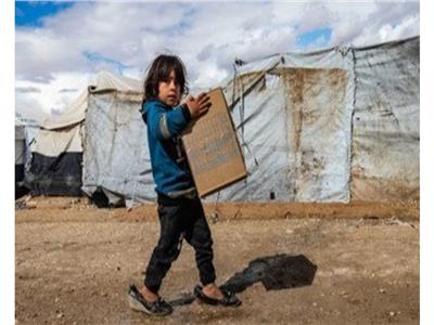 طفلة تحمل مستلزمات شتوية توزعها اليونيسف في مخيم الهول شمال شرق سوريا