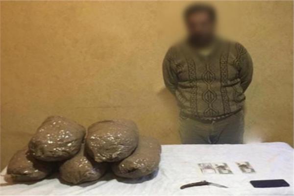 أحد المتهمين وبحوزته المضبوطات