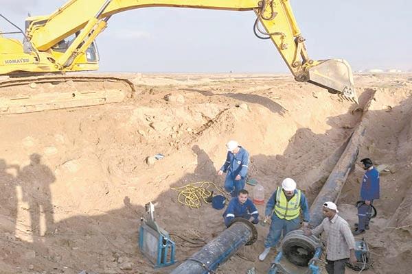العمال أثناء توصيل المواسير