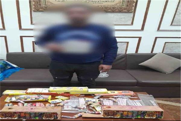 المتهم وأمامه المضبوطات