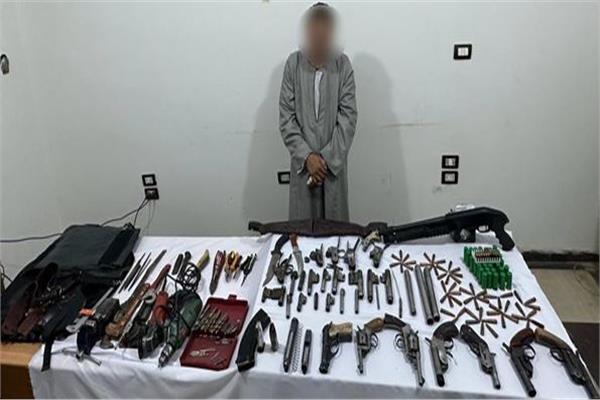 المتهم وأمامه المضبوطات