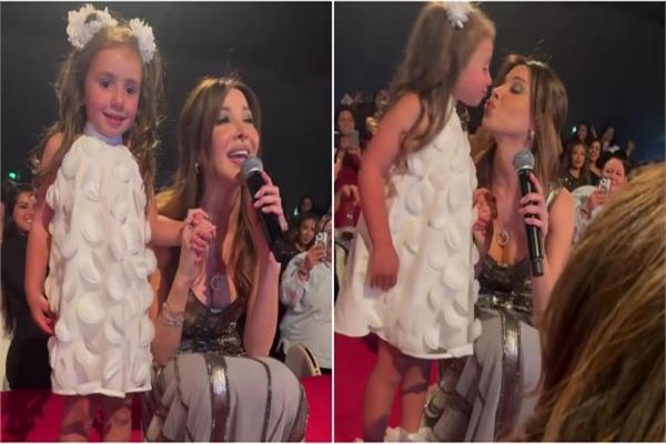 نانسي عجرم مع طفلة في حفلها بهولندا
