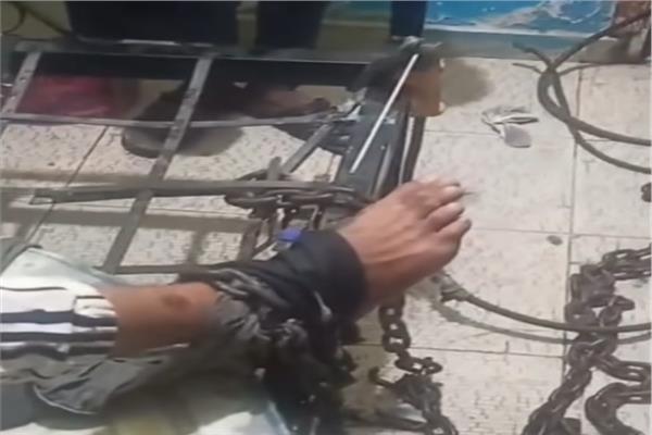 أب يقيّد نجله بسلسلة حديدية 