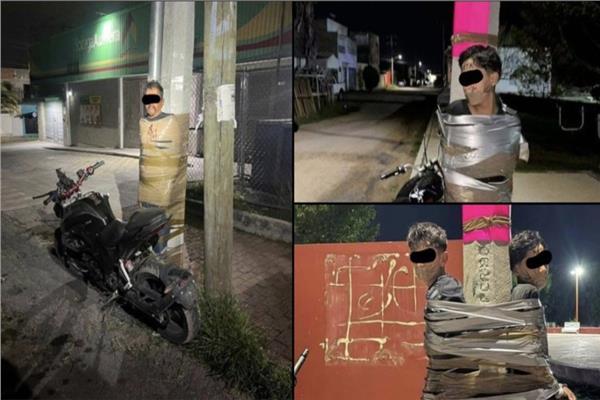رجالًا مقيدين بشريط لاصق إلى أعمدة